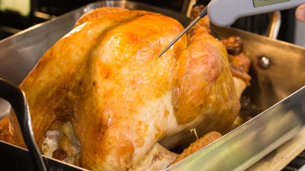 In Lan Lam's recipe, the turkey is cooked in a preheated roasting pan placed on top of a preheated pizza stone or pizza steel to deliver more heat to the legs and thighs. 