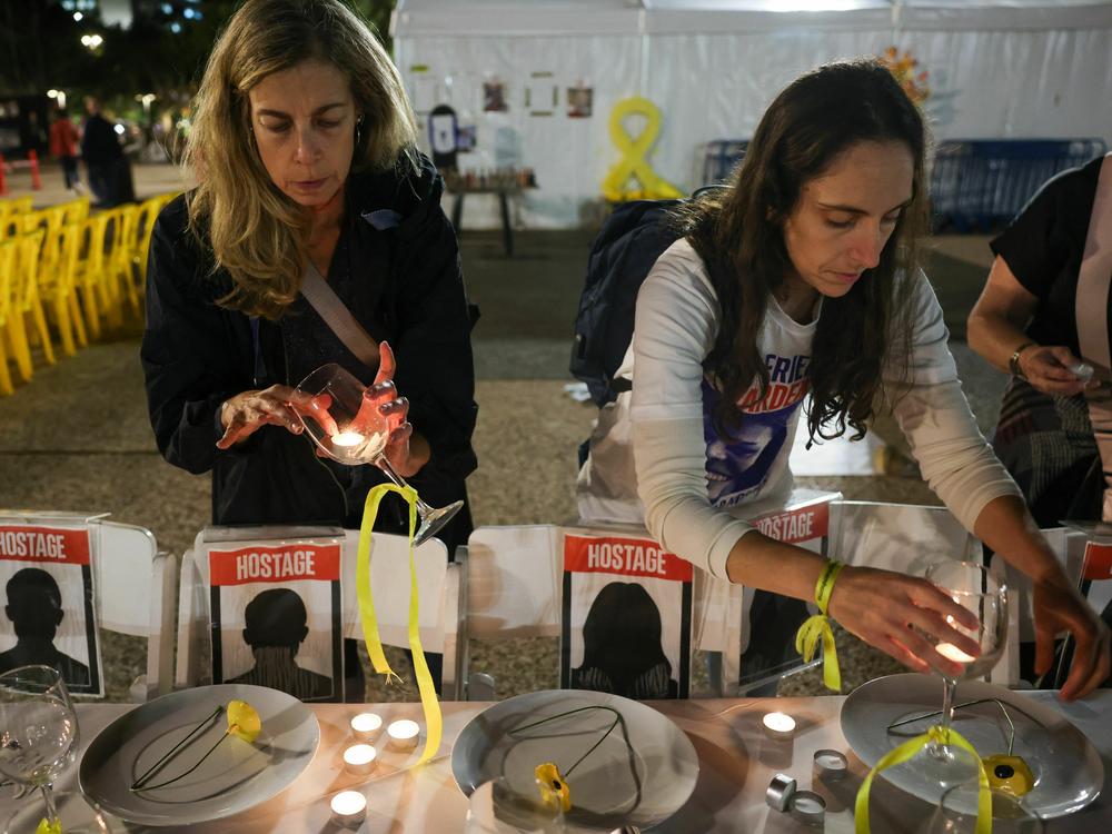 Women prepare a symbolic dinner table during a rally in Tel Aviv, Israel, on Tuesday, demanding the release of Israelis held hostage in the Gaza Strip since the Oct. 7 attack by Hamas militants.