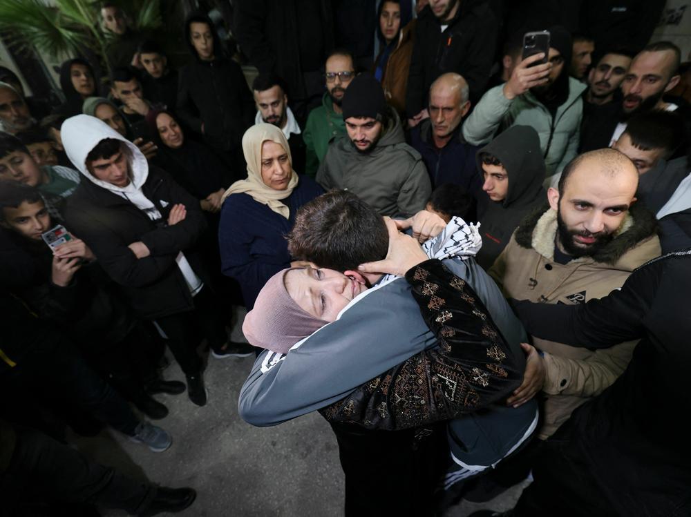 Palestinian prisoner Khalil Zama, right, hugs his mother after being released from an Israeli jail in exchange for Israeli hostages released by Hamas from the Gaza Strip, at his home in Halhul village north Hebron in the occupied West Bank on Monday.