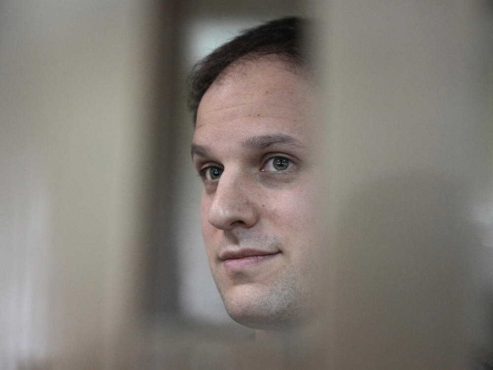 <em>Wall Street Journal</em> reporter Evan Gershkovich stands in a glass cage in a courtroom at the Moscow City Court in Moscow, on Oct. 10. A court in Moscow on Tuesday extended his detention until Jan. 30, Russian news agencies reported.