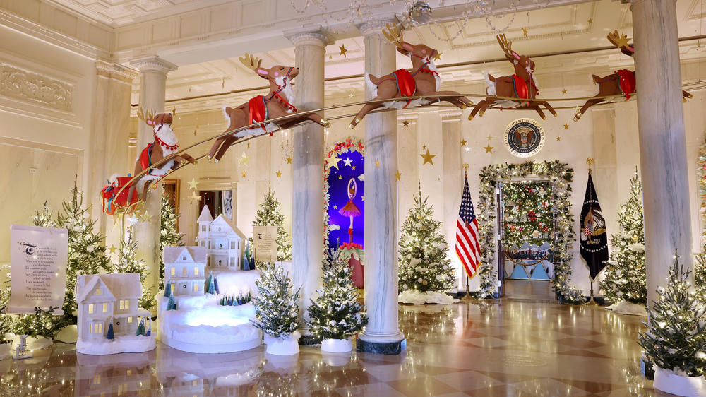 Santa Claus in his sleigh and a team of reindeer fly through the columns of the Entrance Hall of the White House. The theme for this year's White House decorations is 