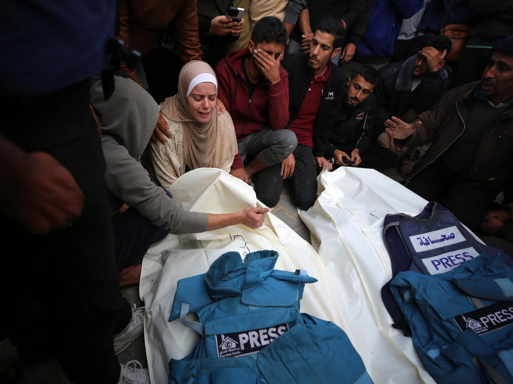 Journalists, relatives and friends pray over the bodies of journalists Sari Mansour and Hassouna Esleem after they were killed in an Israeli bombardment at Bureij camp in the central Gaza Strip on Nov. 19.