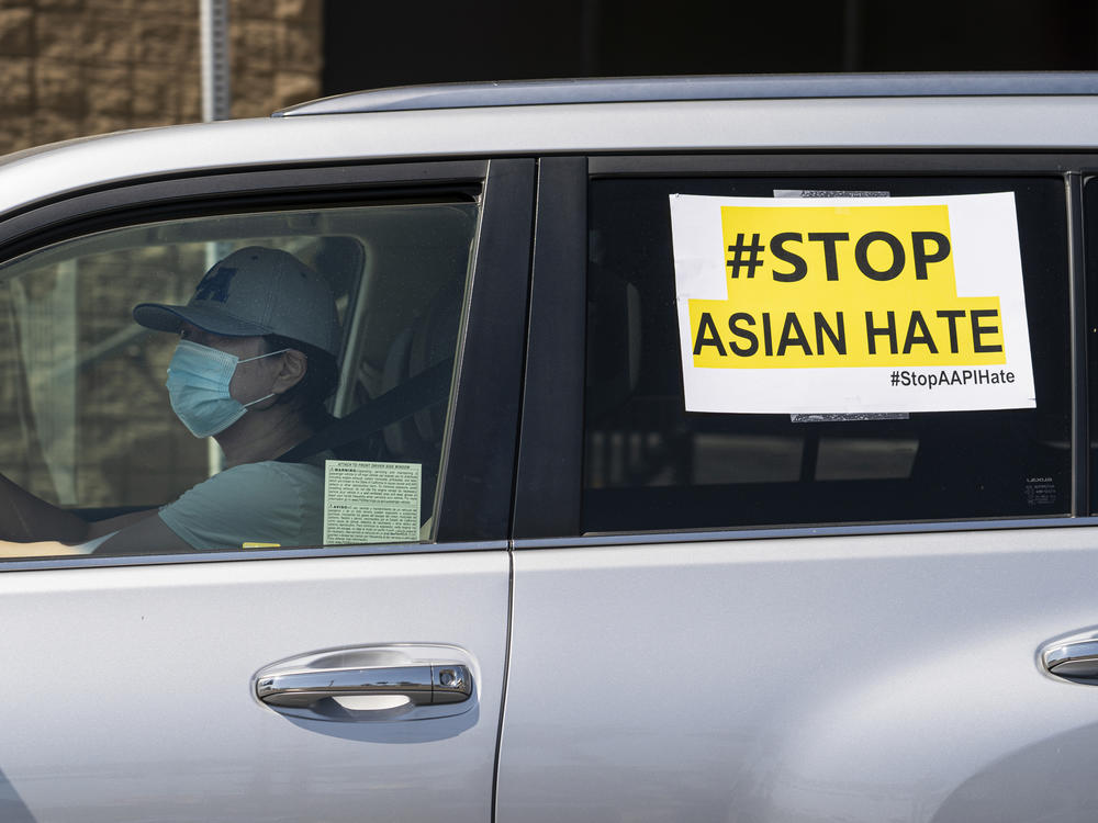 Members of the Korean American Federation of Los Angeles drive with signs reading: 