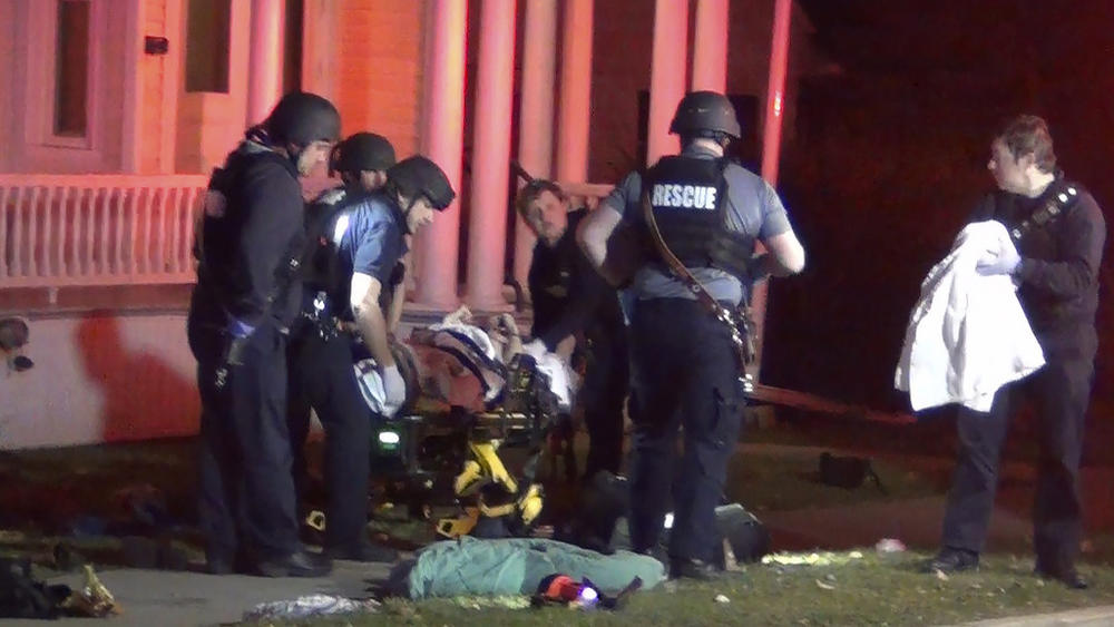 In a still frame from video first responders use a gurney to remove an injured man from the scene of a shooting Saturday in Burlington, Vt. The Burlington Police Department arrested Jason J. Eaton, suspected in the shooting of three young men of Palestinian descent, who were attending a Thanksgiving holiday gathering near the University of Vermont campus Saturday evening.