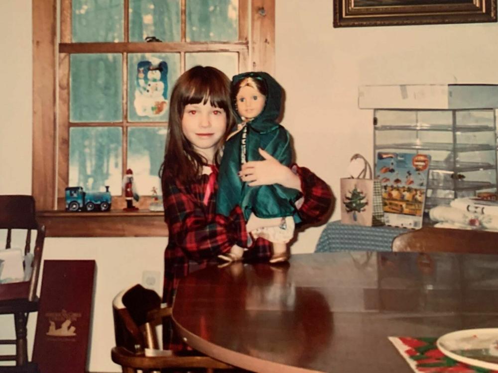 Jessica as a child with an American Girl doll.