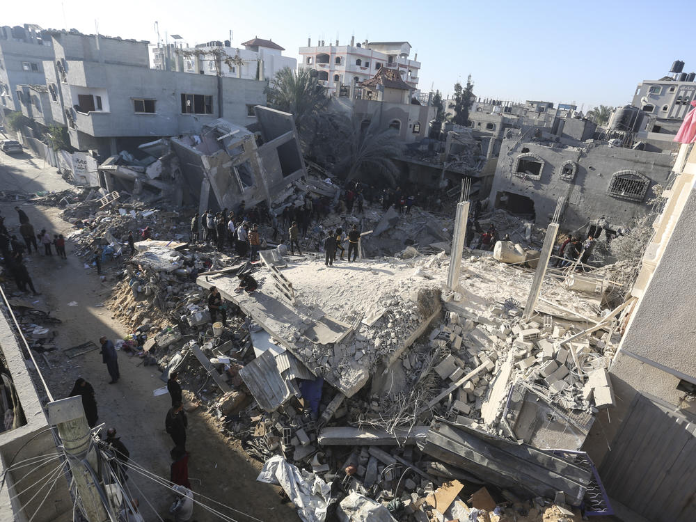 Palestinians look for survivors of the Israeli bombardment of the Gaza Strip in Rafah, on Sunday.