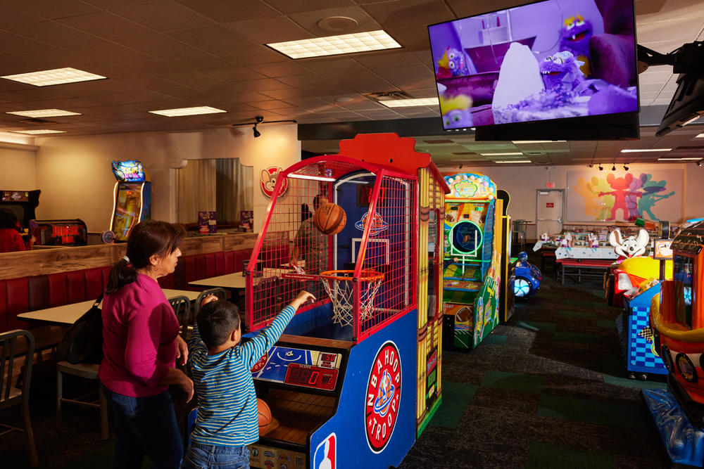 Families play games at the Chuck E. Cheese in Northridge, Calif.