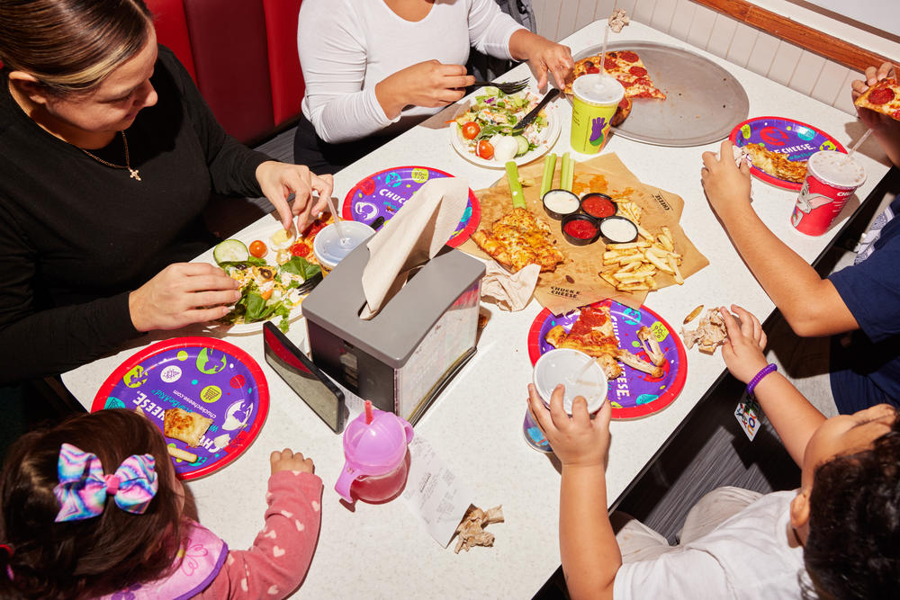 Families grab lunch at the Chuck E. Cheese. In most locations, adults can also order beer and wine at the chain.