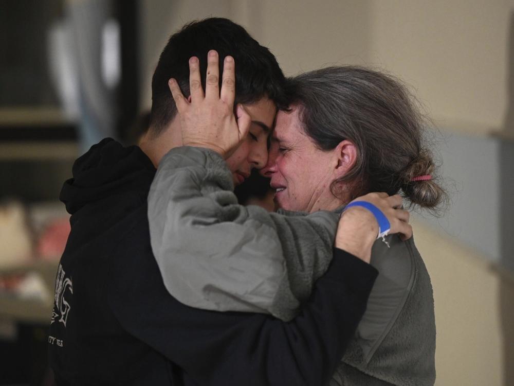 Sharon Hertzman, right, hugs her son, Omer Avigdori, as they reunite at Sheba Medical Center in Ramat Gan, Israel, in November. Hertzman and her daughter, Noam Avigdori, were kidnapped by Hamas on Oct. 7 and released last month.