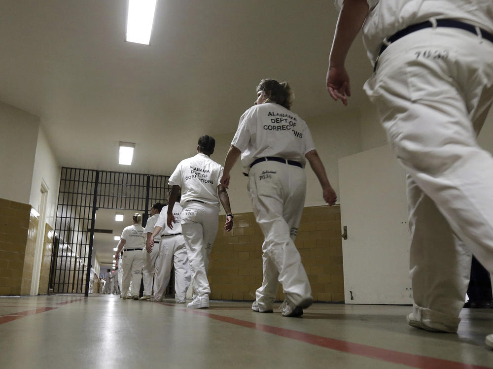 Women at the Tutwiler Prison in Wetumpka, Ala., walk through the halls. This week, current and former prisoners announced a lawsuit challenging Alabama's prison labor program as a type of modern slavery.