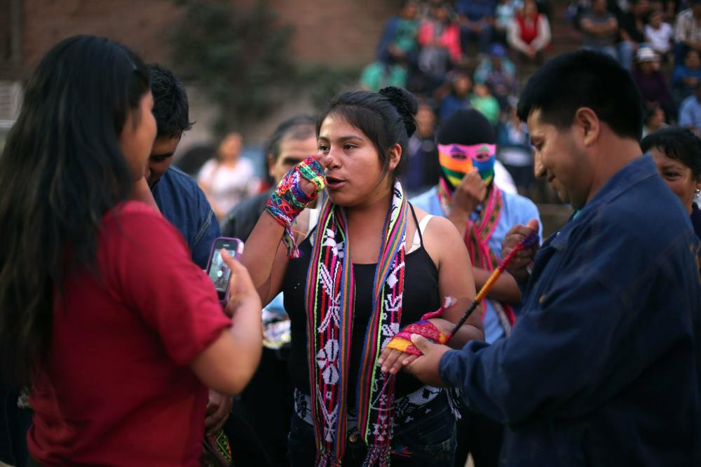 In this Dec. 25, 2015, photo, Karen Quispe prepares to fight another woman for sport at the <em>Takanakuy</em> ritual fighting event on the outskirts of Lima, Peru. Taking part in the fights is voluntary, and no one is obligated to accept a challenge. But by refusing to participate, the challenged party automatically acknowledges the superiority of their rival.