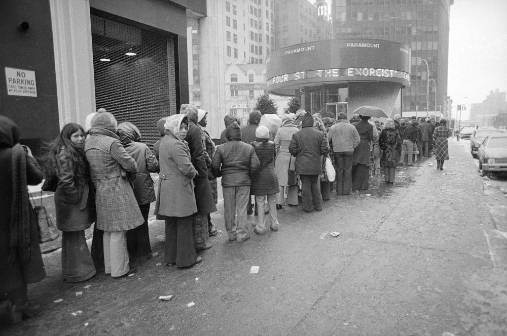 Despite subfreezing temperatures and rain, a crowd waits in line outside the Paramount Theater in New York City for a showing of <em>The Exorcist</em> in February 1974.