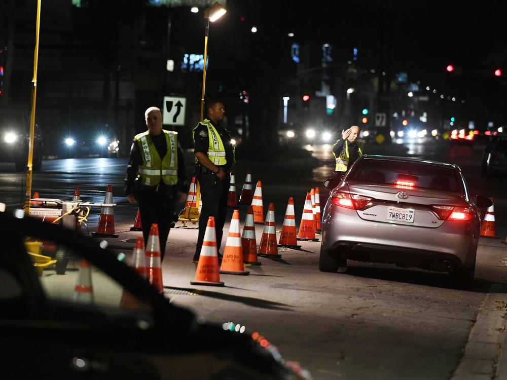 Los Angeles Police Department officers check drivers at a DUI checkpoint in Reseda, Los Angeles, California on April 13, 2018.