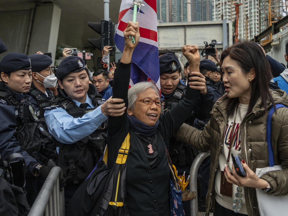 Activist Alexandra Wong, also known as Grandma Wong, is escorted into a barricade outside West Kowloon Magistrates' Courts, where activist publisher Jimmy Lai's trial is scheduled to open, in Hong Kong, Monday, Dec. 18, 2023.