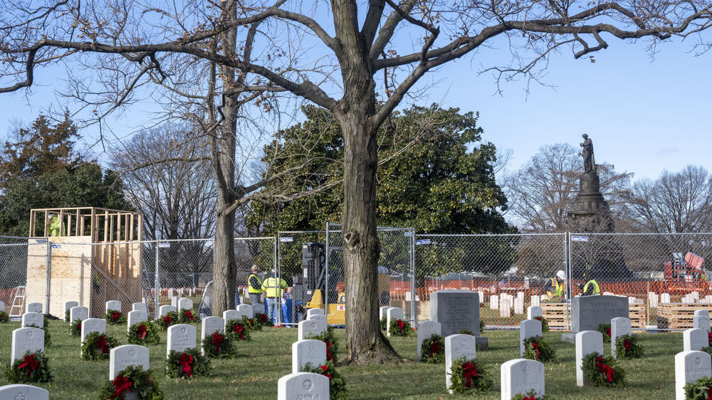 Workers build a crate to hold the statue as they prepare to remove it from Arlington National Cemetery on Monday.