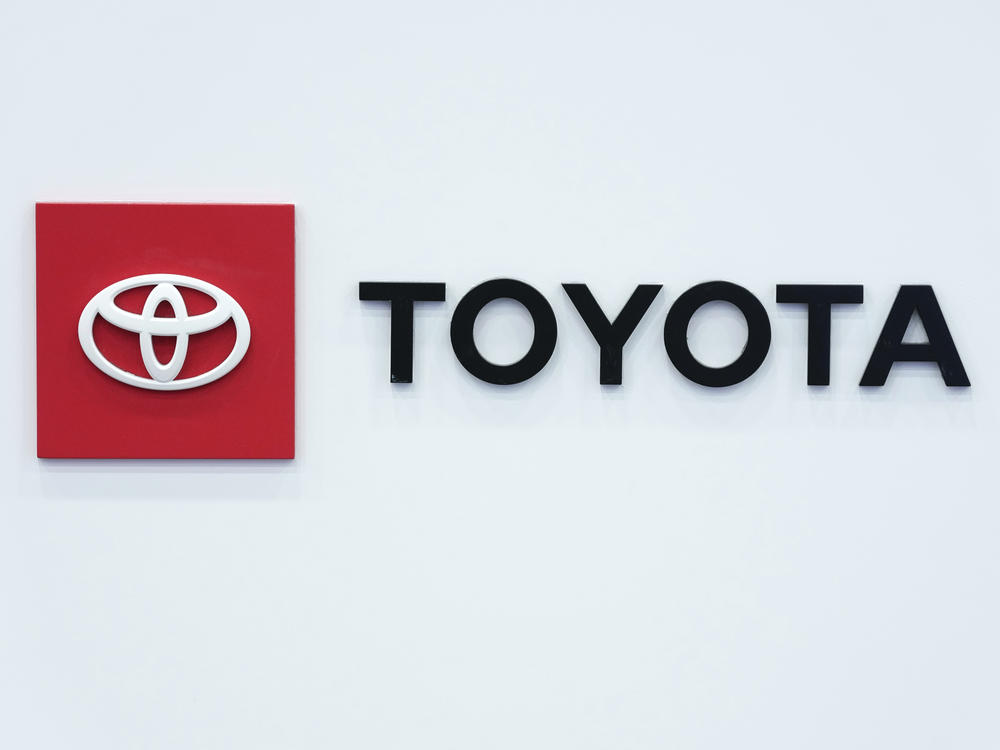 The Toyota logo is seen on Sept. 13 at the North American International Auto Show in Detroit. That automaker says it is recalling 1 million vehicles over a defect that could cause airbags not to deploy, increasing the risk of injury.