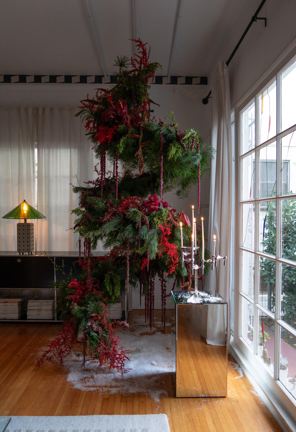 The floating Christmas tree, created by Marco Zamora and Juan Renteria, is suspended from the ceiling with the help of three shower curtain tension rods and fish line.