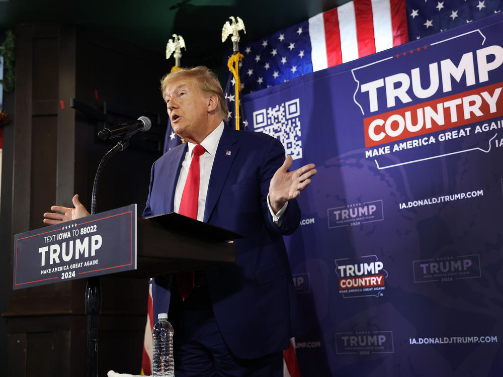 Former President Donald Trump speaks at a commit to caucus campaign event at the Whiskey River bar on Dec. 2 in Ankeny, Iowa.
