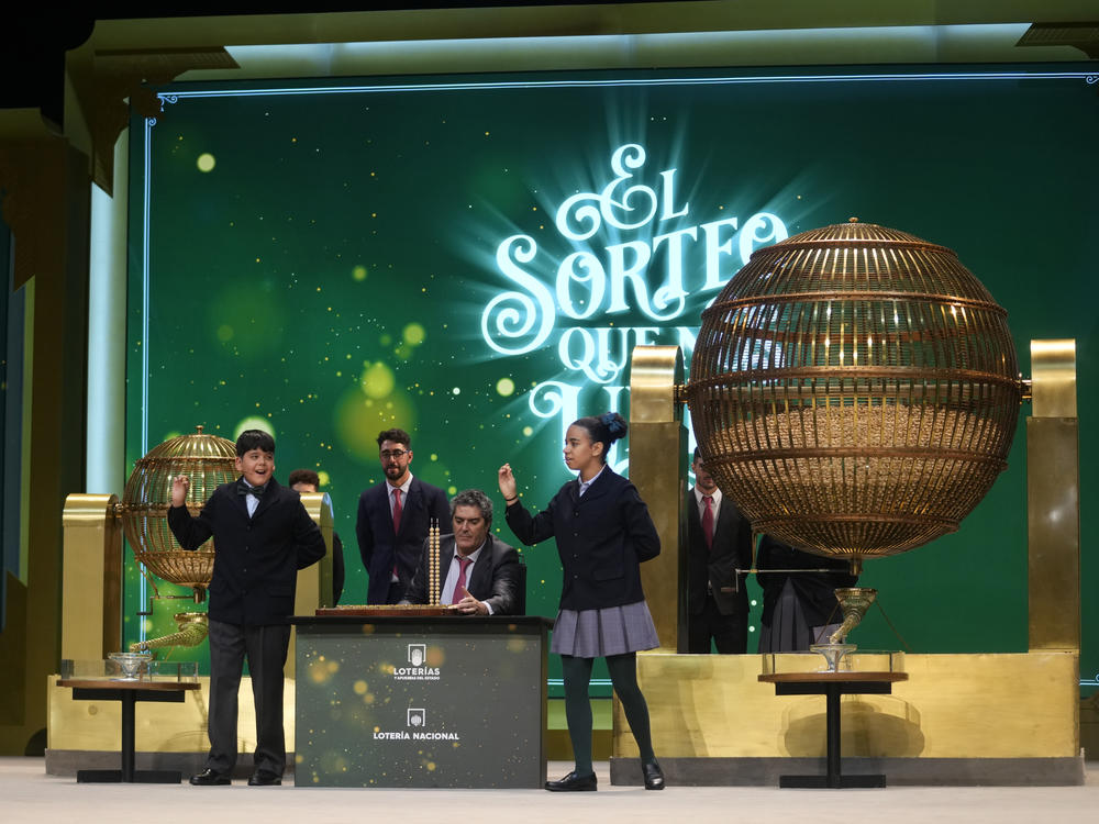 Children from Madrid's San Ildefonso school sing out the numbers from one of the main prizes from awarded lottery balls in Madrid, Spain, Friday, Dec. 22, 2023.