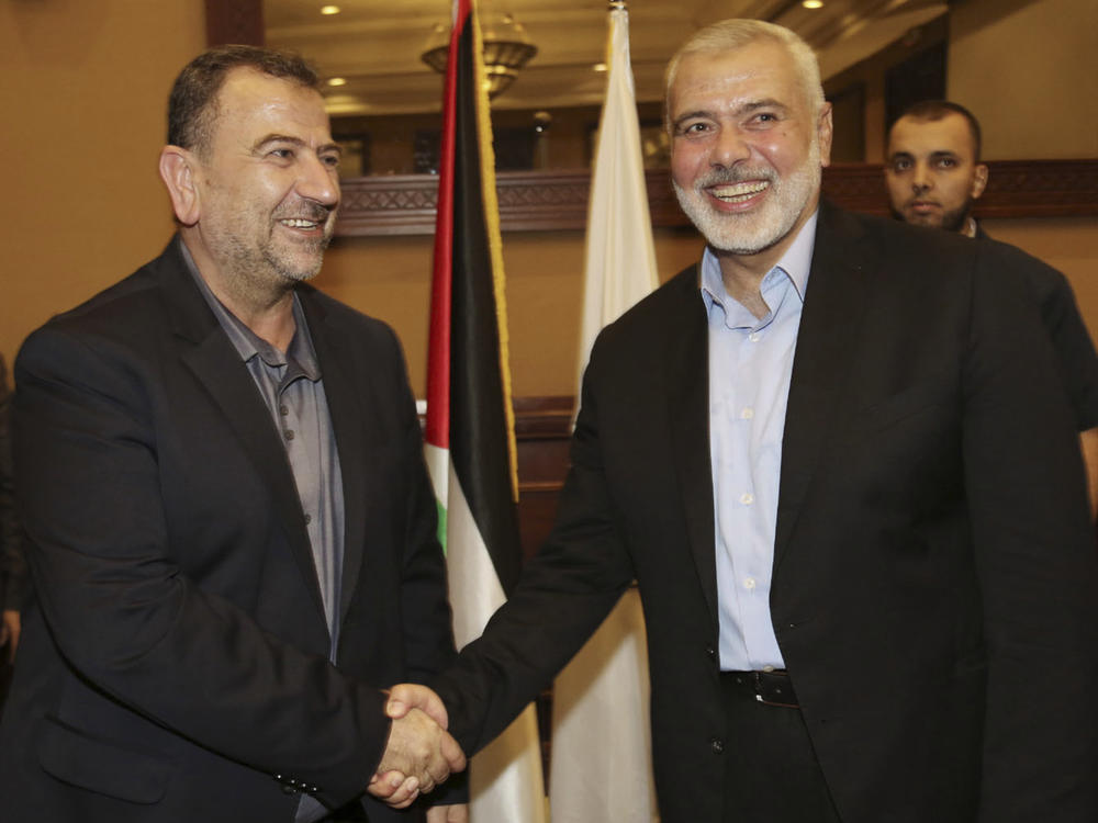 Ismail Haniyeh (right), the head of Hamas' political bureau, shakes hands with his deputy, Saleh Arouri, upon his arrival in Gaza City from Cairo on Aug. 2, 2018. A TV station of Lebanon's Hezbollah group says Arouri was killed Tuesday in an explosion in a southern Beirut suburb.