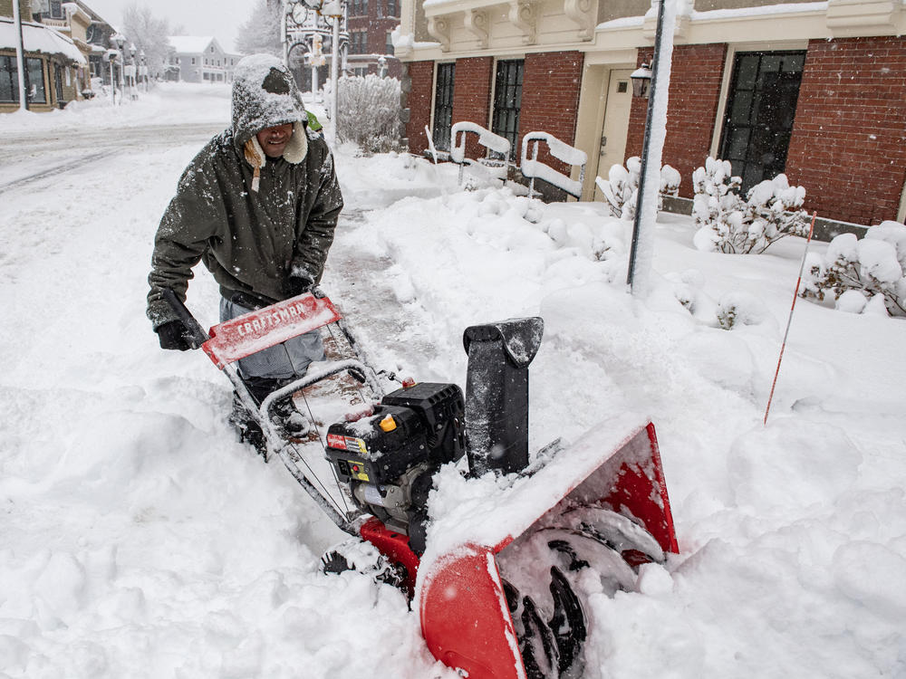 A person uses a snowblower to clear snow in front of a home in Methuen, Mass., on Sunday.