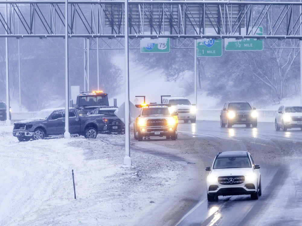 Omaha police and a tow truck respond to an accident on Interstate 480 in Omaha, Neb., on Tuesday, Jan. 9, 2024.