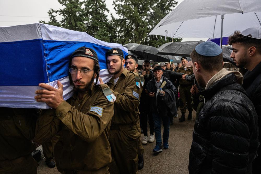 The casket bearing the body of Israeli Sgt. Amit Hod Ziv, 19, who was killed in a Hezbollah rocket attack near the border with Lebanon in northern Israel, is carried at his funeral in Rosh Haayin, Israel, on Dec. 24.