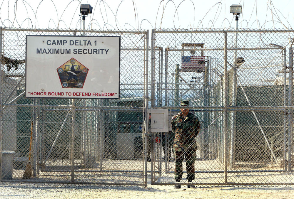 A U.S. Army soldier stands at the entrance to Camp Delta where detainees from the U.S. war in Afghanistan live on April 7, 2004 in Guantánamo Bay.