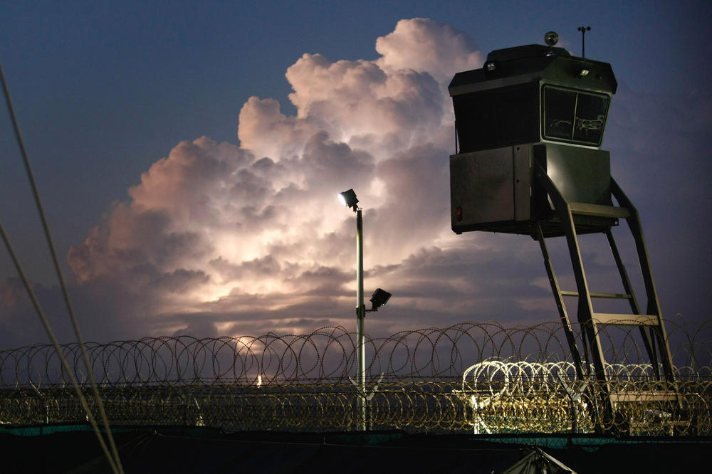 A mobile guard tower stands over a Guantánamo Bay camp.