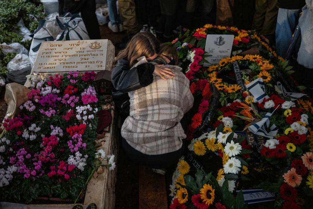 People grieve beside the grave of Israeli Sgt. Amit Hod Ziv, 19, who was killed in a Hezbollah rocket attack near the border with Lebanon in northern Israel. They were attending his funeral in Rosh HaAyin, Israel, on Dec. 24.
