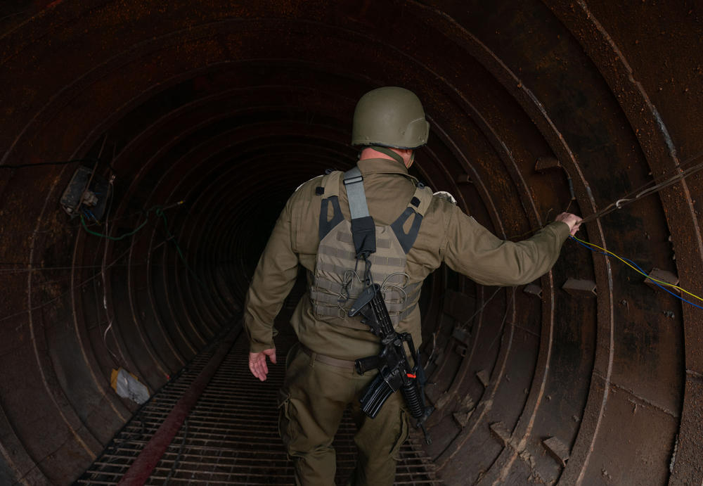 An Israeli soldier on Dec. 27 makes his way into a tunnel that the Israeli military says Hamas used to attack Israel through the Erez border crossing on Oct. 7.