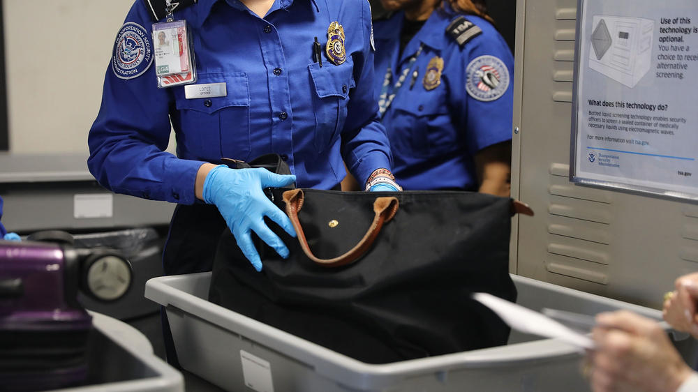 A Transportation Security Administration worker screens luggage at New York's LaGuardia Airport on Sept. 26, 2017. The TSA says it found a record number of firearms at airport security checkpoints last year.
