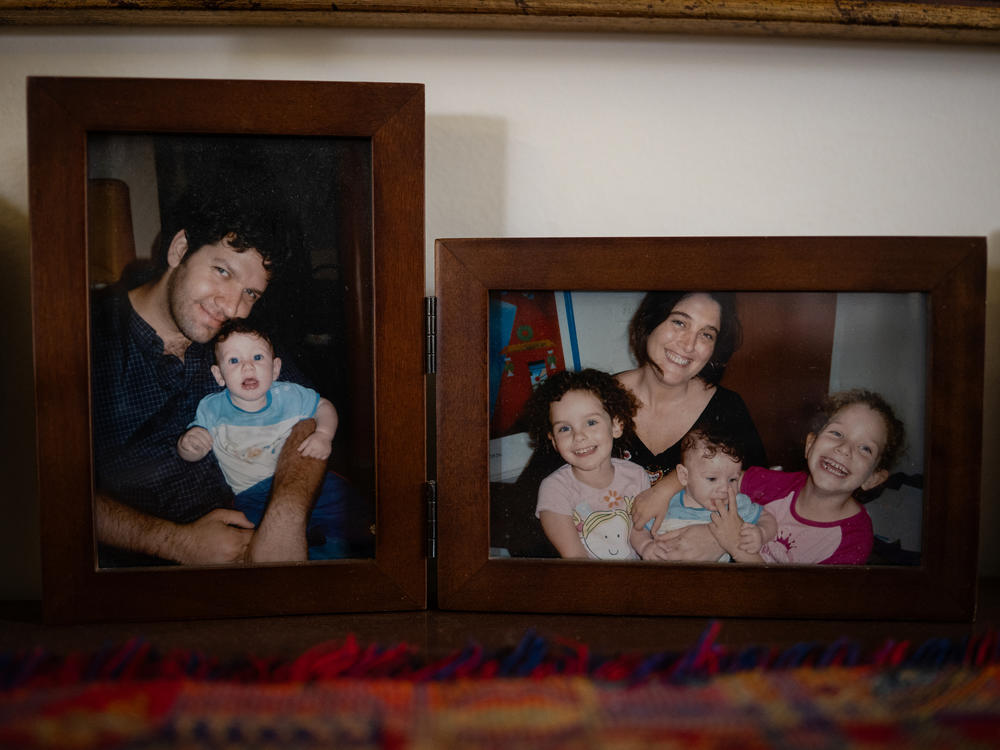 Photographs of Deborah and Shlomi Mathias with their three children are displayed at Deborah's parents' home in Omer, Israel.