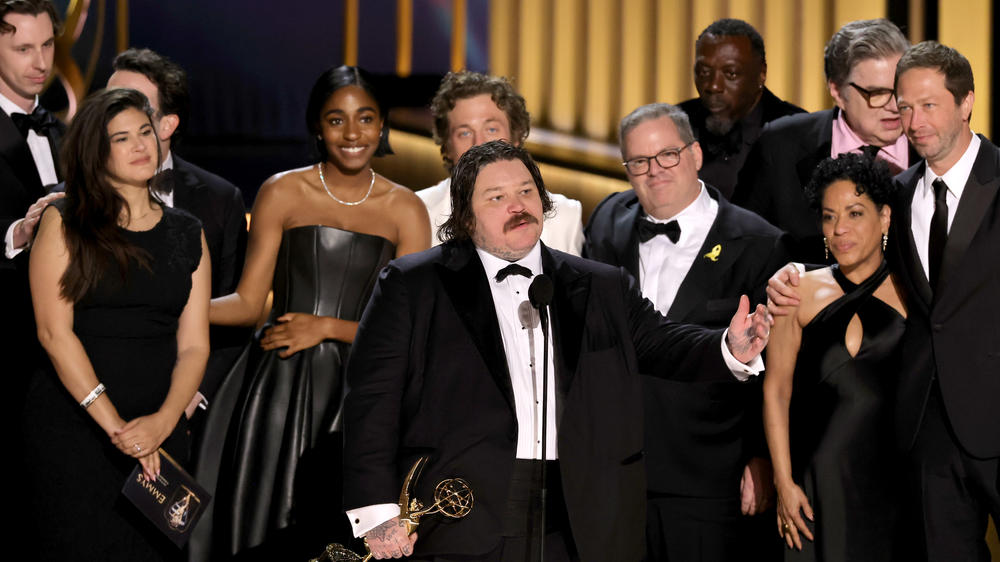 From left to right: Christopher Storer, Joanna Calo, Ayo Edebiri, Matty Matheson, Jeremy Allen White, Tyson Bidner, Edwin Lee Gibson, Liza Colón-Zayas, Oliver Platt, and Ebon Moss-Bachrach accept the Outstanding Comedy Series award for <em>The Bear</em> onstage during the 2024 Emmys.