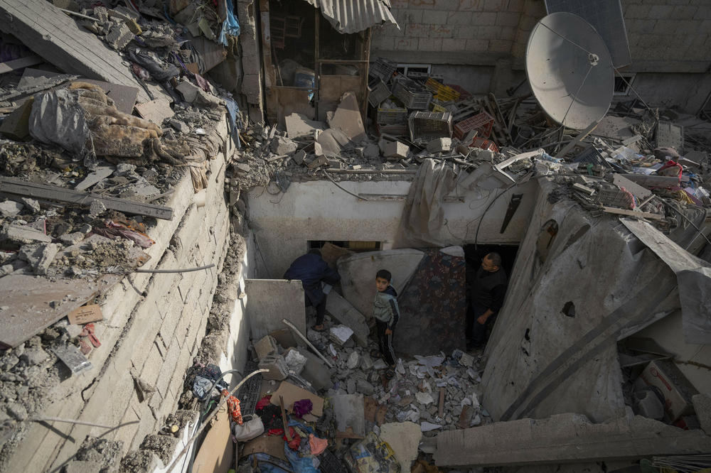 Palestinians look at the destruction after an Israeli strike in Rafah, is southern Gaza, on Jan. 17.