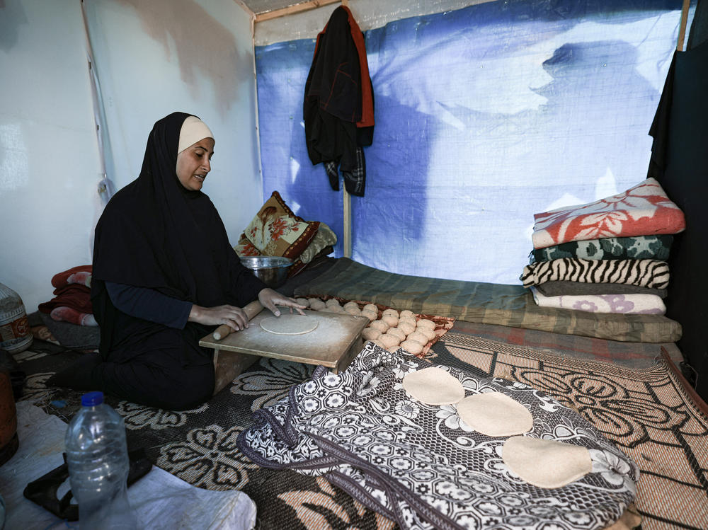 A displaced Palestinian woman prepares bread inside a tent at a makeshift camp in Rafah near the Gaza-Egypt border earlier this month.