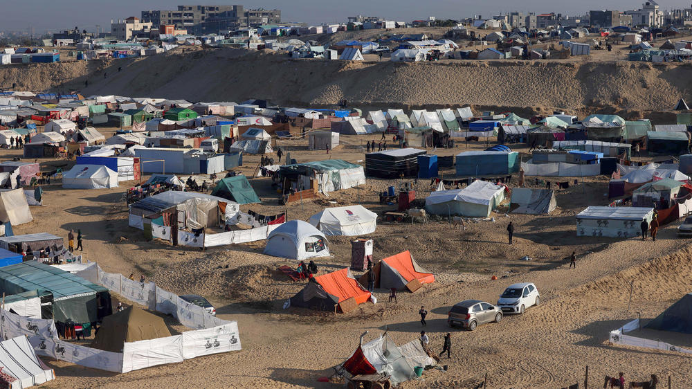 Displaced Palestinians take shelter in a makeshift tent camp by the beach in Rafah near the border with Egypt in the southern Gaza Strip on Tuesday, amid the ongoing conflict between Israel and the Palestinian militant group Hamas.
