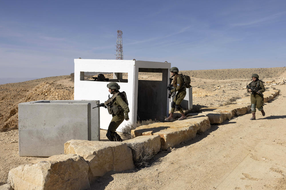 Israeli women soldiers, from the mixed gender infantry unit of the Bardelas battalion, take part in a training exercise along the Israel-Egypt border on Jan. 18.