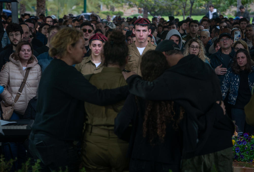 The family of Israeli soldier Ilay Levy mourns during his funeral at the military cemetery in Tel Aviv on Jan. 23, after he was killed in combat in Gaza during an incident that claimed the lives of nearly two dozen Israeli soldiers.