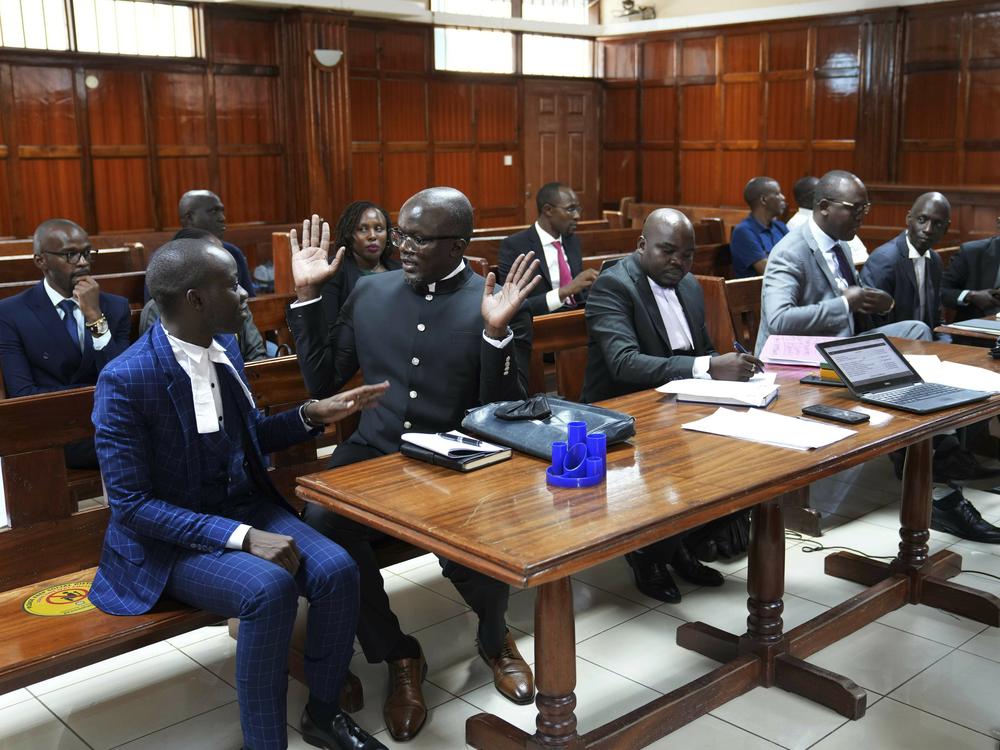 Lawyers react as Justice Chacha Mwita delivers judgement on a petition against the deployment of Kenyan forces to Haiti, at Milimani court in the capital Nairobi, Kenya, Friday, Jan. 26, 2024.