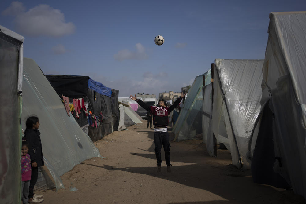 Palestinians displaced by Israel's ground offensive on the Gaza Strip play at the makeshift tent camp in Rafah on Jan. 23.