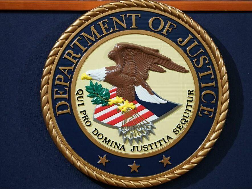 The U.S. Department of Justice seal is seen on a lectern.