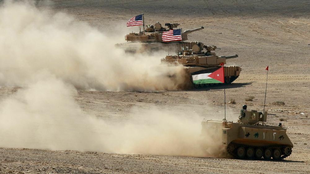 A Jordanian armored personnel carrier and U.S. tanks take part in the 
