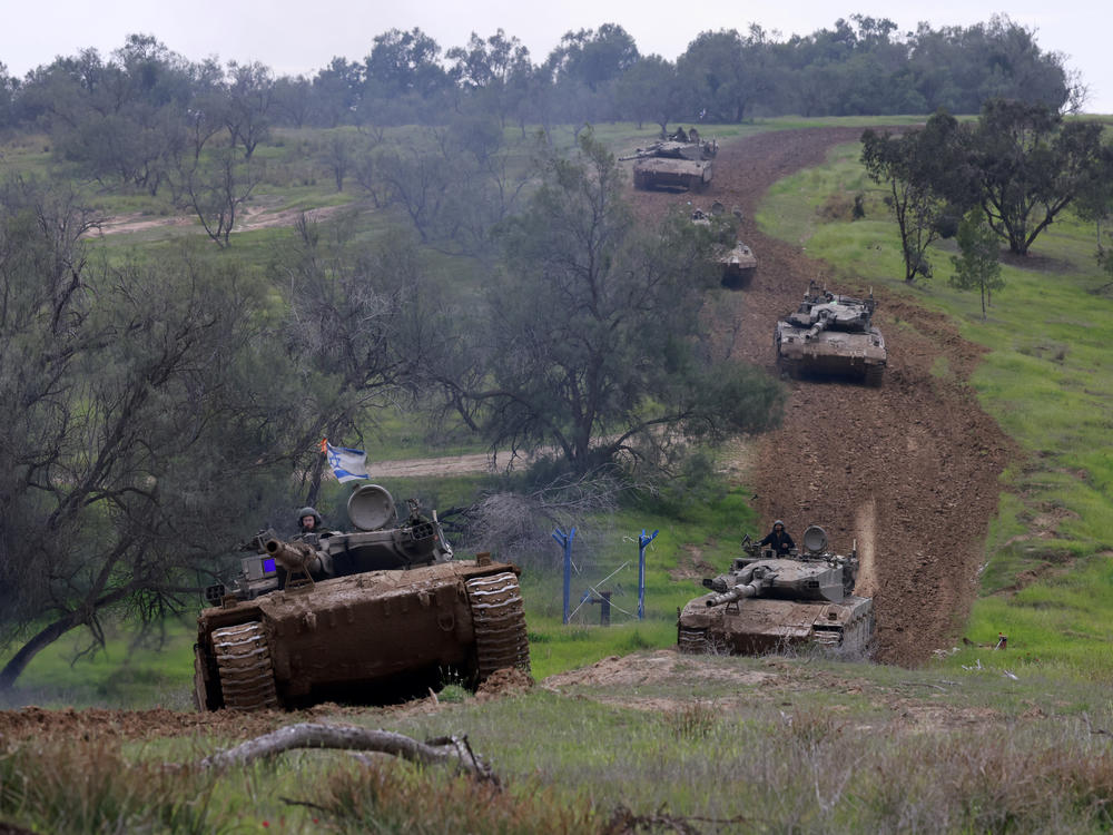A unit of Israeli soldiers return with their tanks to the Israeli side of the border with the Gaza Strip on Sunday, after spending months in the Palestinian territory engaged.