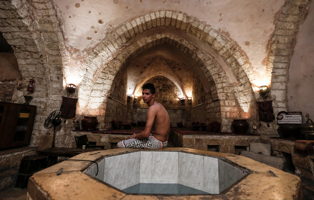 A Palestinian man relaxes at the ancient Samaritan Hammam, a traditional Turkish steam bath, in Gaza City, on March 3, 2021.