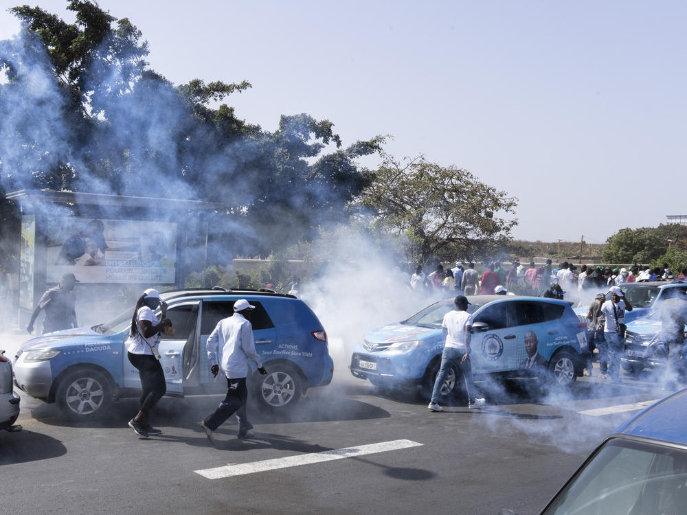 Senegalese riot police lob tear gas at supporters of opposition presidential candidate Daouda Ndiaye, in Dakar, Senegal, on Sunday.