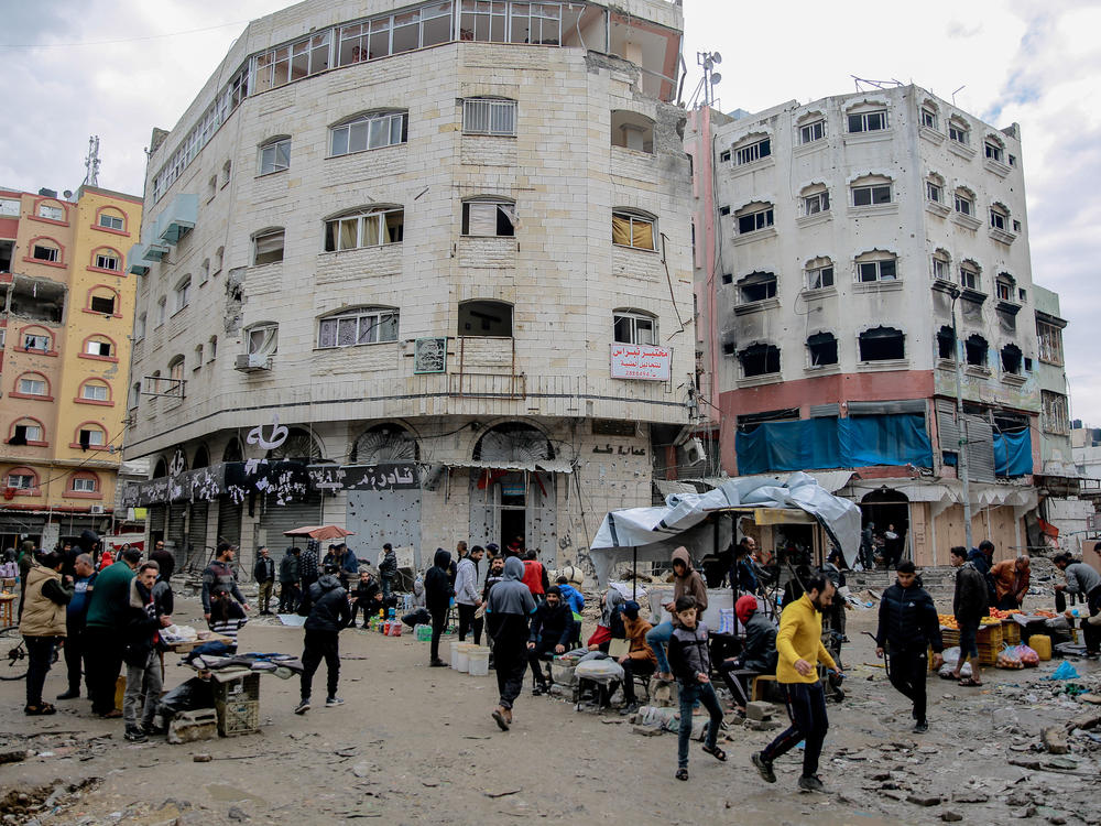 On a January day, people explore the streets of Gaza City, where researchers estimate 72% or more of buildings have been damaged or destroyed.