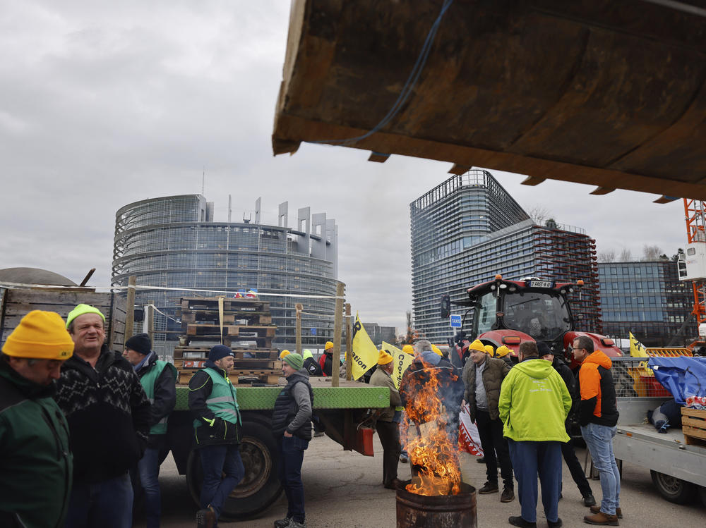 Farmers gather outside the European Parliament for a protest, in Strasbourg, eastern France, Tuesday, Feb. 6, 2024.