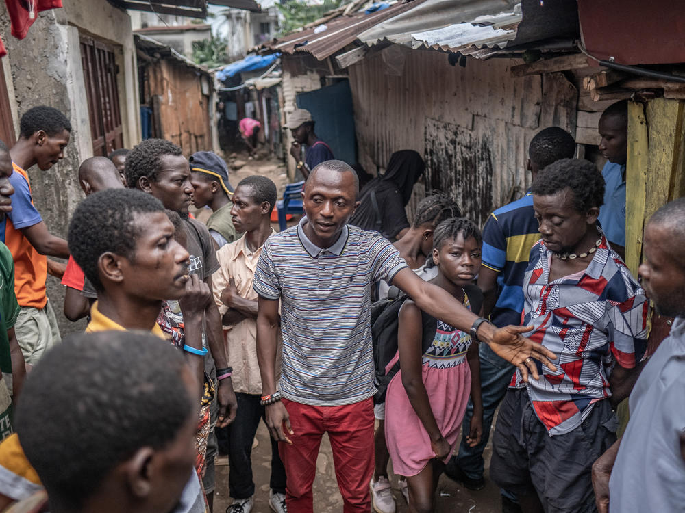 Ibrahim Koroma of the Mental Watch Advocacy Network, a local civil society organization, warns of the dangers of kush in a poor neighborhood in Western Freetown, Sierra Leone. 