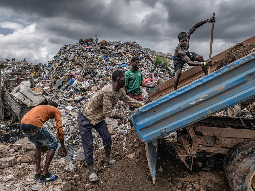The kush epidemic is unfolding against a backdrop of poverty in much of Sierra Leone. Here, young men sort through rubble at the Kingtom dumpsite in Freetown.